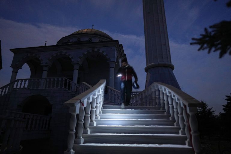 Turkish imam Mehmet Yuce walks down the steps after evening pray in a mosque in Mariupol, Ukraine, Saturday, March 12, 2022. The Ukrainian Embassy in Turkey says a group of 86 Turkish nationals, including 34 children, are among those sheltering in a mosque in the besieged city of Mariupol