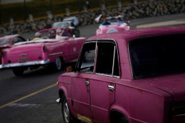 A vintage Russian-made Lada car, right, parks in Havana, Cuba