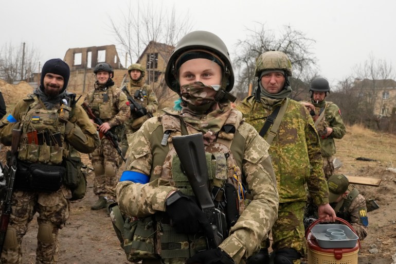 Ukrainian soldiers smile as they have a rest