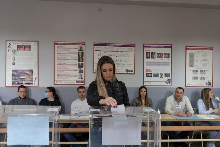 A woman votes at a polling station in Belgrade