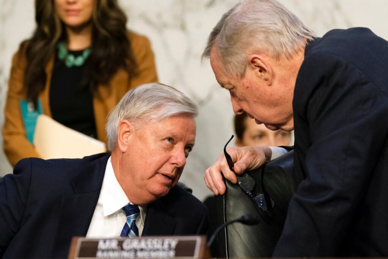 Senate Judiciary Committee Chairman Sen. Dick Durbin, D-Ill., right, talks to Sen. Lindsey Graham, R-S.C., before resuming the committee's business meeting to consider the confirmation of Supreme Court nominee Judge Ketanji Brown Jackson on Capitol Hill.
