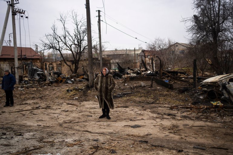 Woman stands amid the destruction in Bucha, Ukraine.
