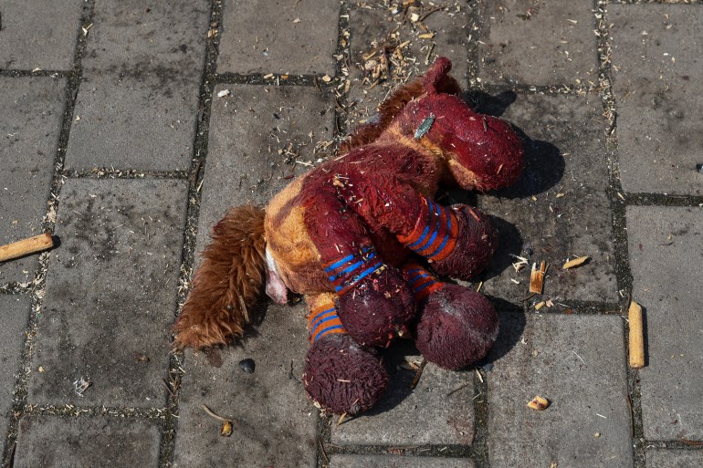 A stuffed horse with bloodstains on it