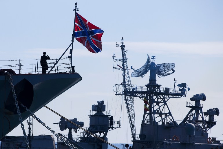 A Russian sailor salutes on the bow of the Moskva.
