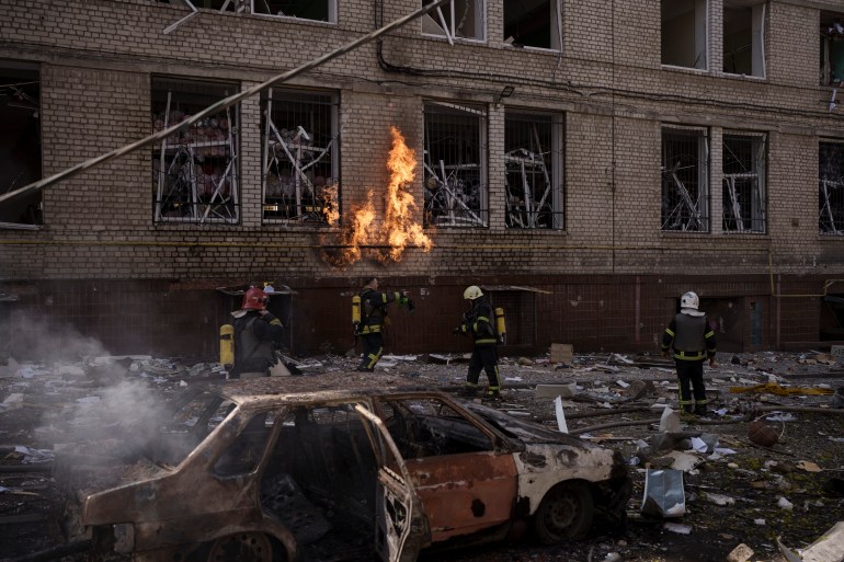 Firefighters work to extinguish multiple fires after a Russian attack in Kharkiv