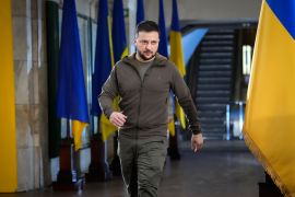 Ukrainian President Volodymyr Zelenskyy walks ahead of a press conference in a city subway under a central square in Kyiv