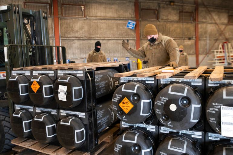 Airmen and civilians from the 436th Aerial Port Squadron palletize ammunition, weapons and other equipment bound for Ukraine during a foreign military sales mission at Dover Air Force Base, Delaware.