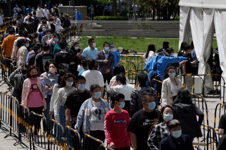 Residents line up for COVID mass testing near tents set up at a plaza in the Haidian district on Tuesday, April 26, 2022, in Beijing.