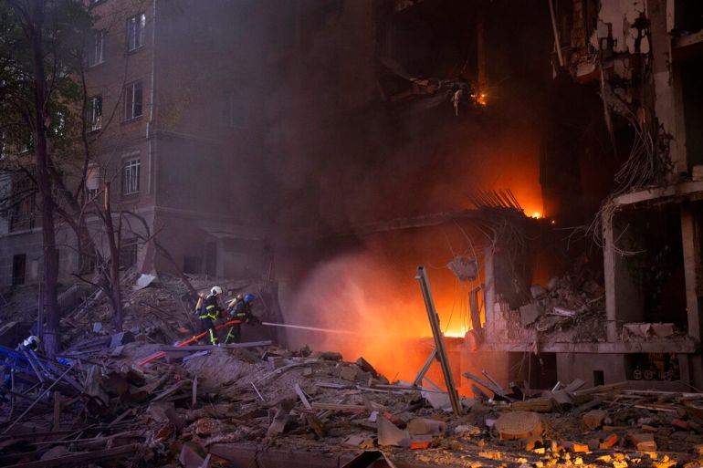 Firefighters try to put out a fire following an explosion in Kyiv, Ukraine. Russia mounted attacks across a wide area of Ukraine on Thursday, bombarding Kyiv during a visit by the head of the United Nations.