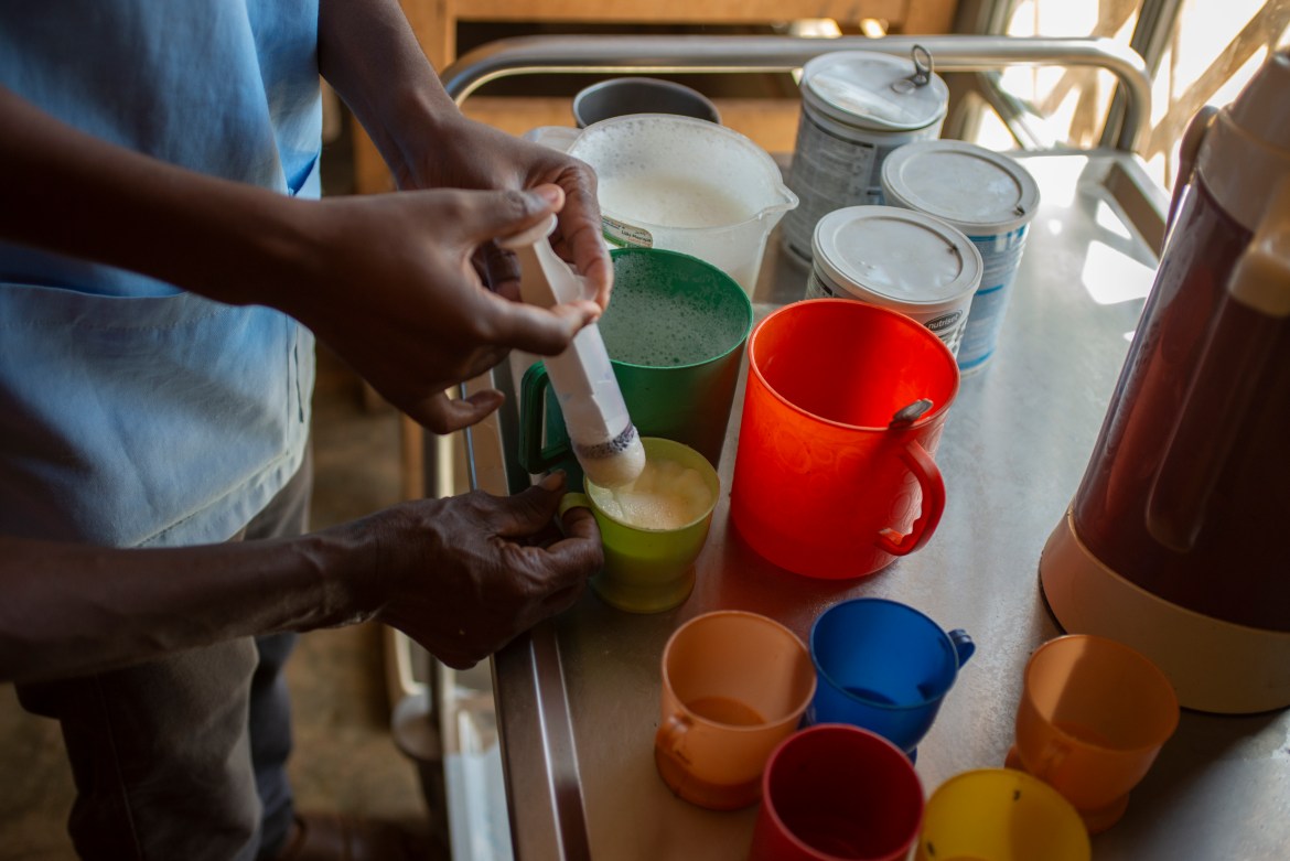 A nurse mixes therapeutic milk at the hospital in Ambovombe. An analysis by the Integrated Food Security Phase Classification (IPC) said a total of 309,000 children are expected to face acute malnutrition in southern Madagascar between November 2021 and August 2022, with a total of 60,000 projected to face severe acute malnutrition. [Joseph Stepansky/Al Jazeera]