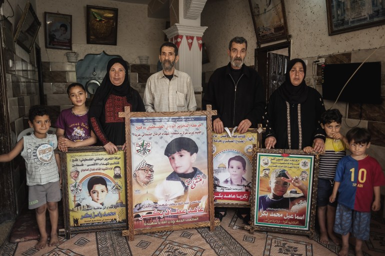 Parents of Bakr children holding their photos