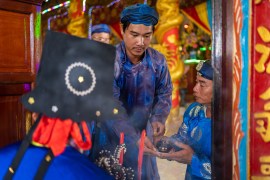 Worshippers in Phuoc Hai pay their respects to the whale god, Cá Ông [Magnus Graham/Al Jazeera]