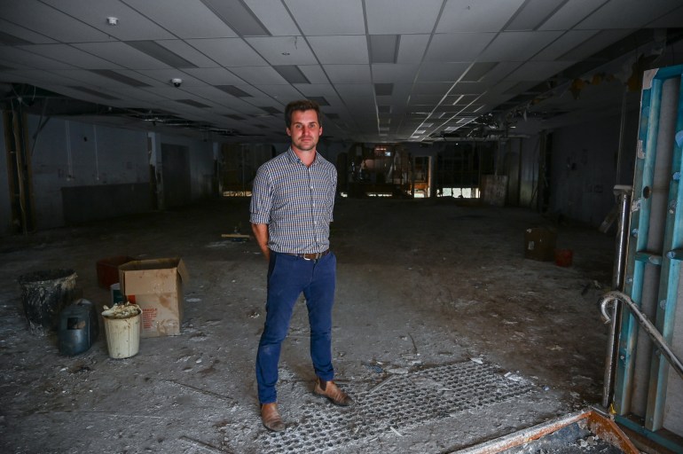  Lismore chemist owner Kyle Wood stands amongst the remains of his main chemist building