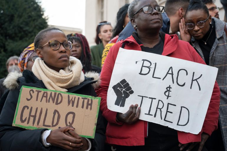 Protesters seen in front of Hackney Town Hall holding placards that read "stand with child Q" and "Black and tired"