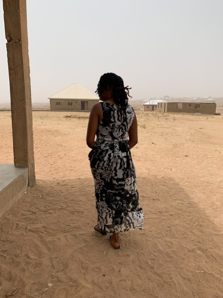 A woman walks with her back facing the camera