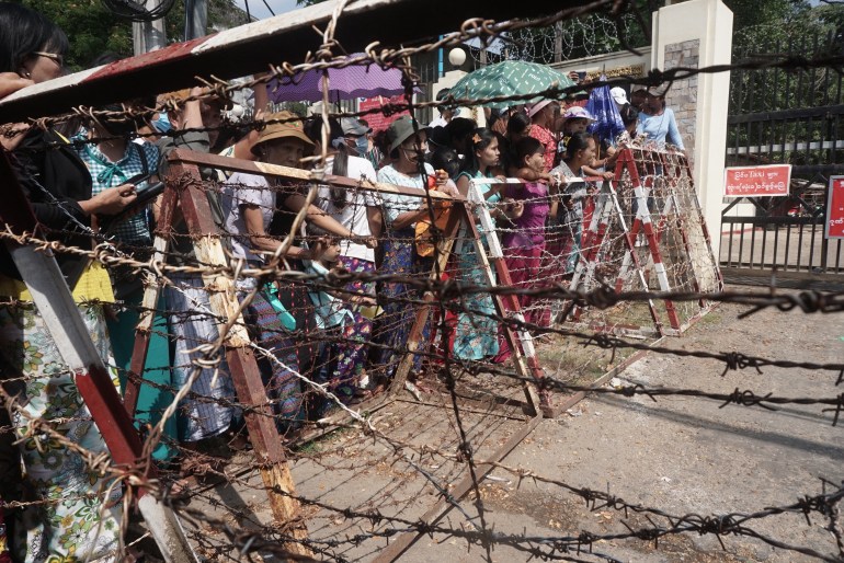 Relatives wait in front of the Insein Prison for the release of prisoners in Yangon on April 17, 2022 [AFP]