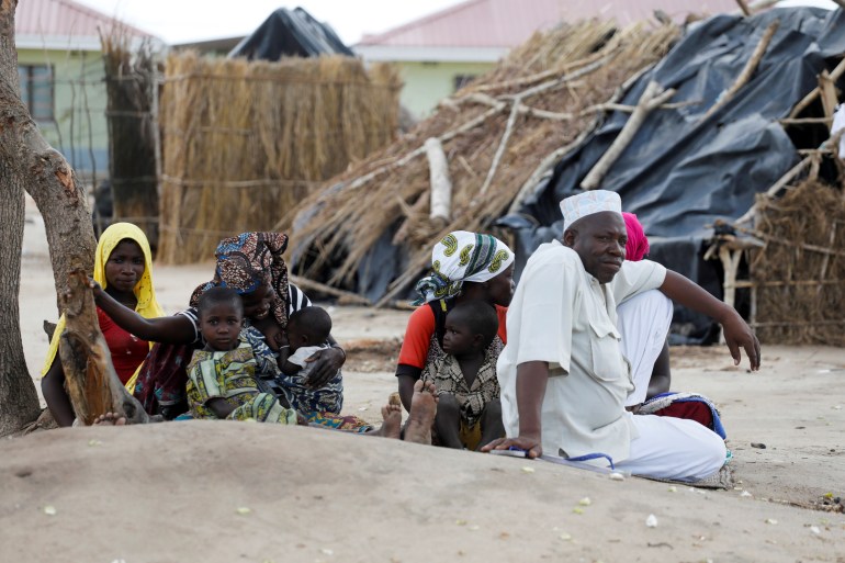 A family displaced by fighting sit inside a camp for the internally displaced in the town of Quitunda, Mozambique 