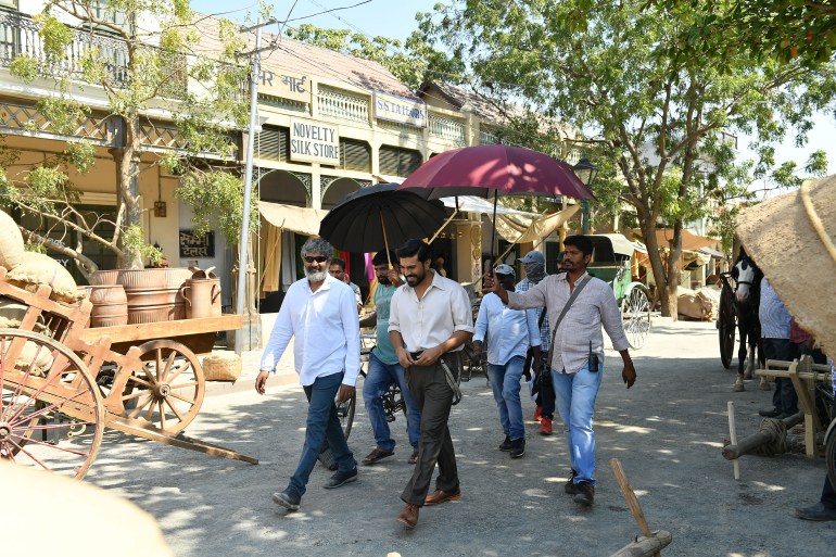 Director SS Rajamouli (left) and Telugu film star Ram Charan on the sets of RRR [Media House Global]