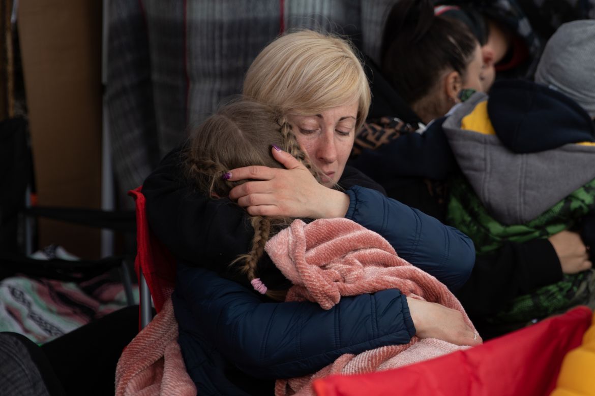 A Ukrainian mother holds her child as they wait to seek asylum in Tijuana, Mexico.