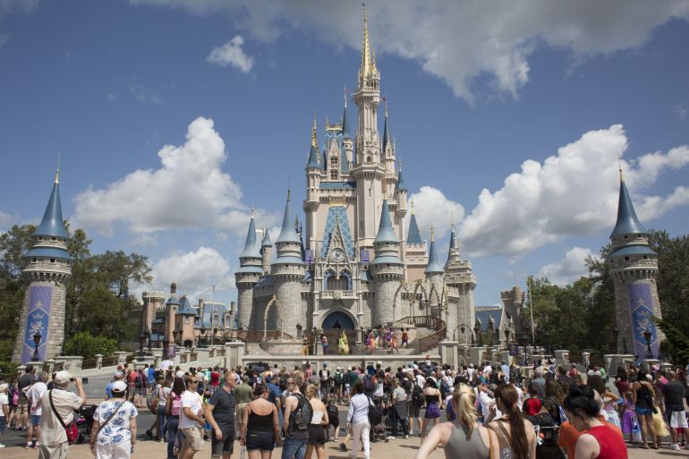 Visitors watch a performance at the Cinderella Castle at the Walt Disney Co. Magic Kingdom park in Orlando, Florida, U.S