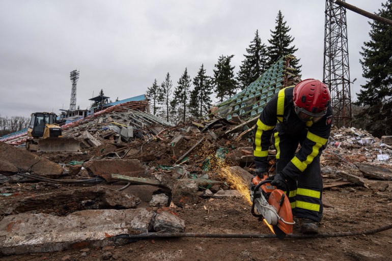 Firefighter works at a stadium damaged by Russian shelling in Chernihiv, Ukraine