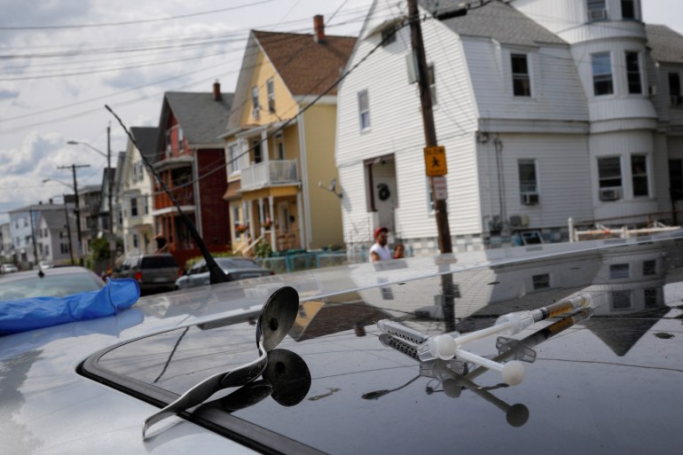 A full syringe, empty syringe and spoon sit on the roof of the car in which a man in his 20's overdosed on an opioid in the Boston suburb of Lynn, Massachusetts