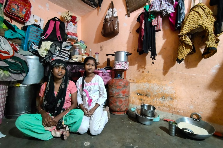 Kaushilya Devi, domestic help, with her daughter Rakhi at their home in Delhi, India