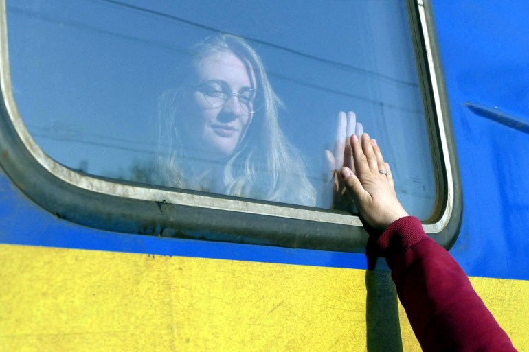 Woman says goodbye to relative aboard a train travelling to Poland, amid Russia's invasion of Ukraine, in Odesa.
