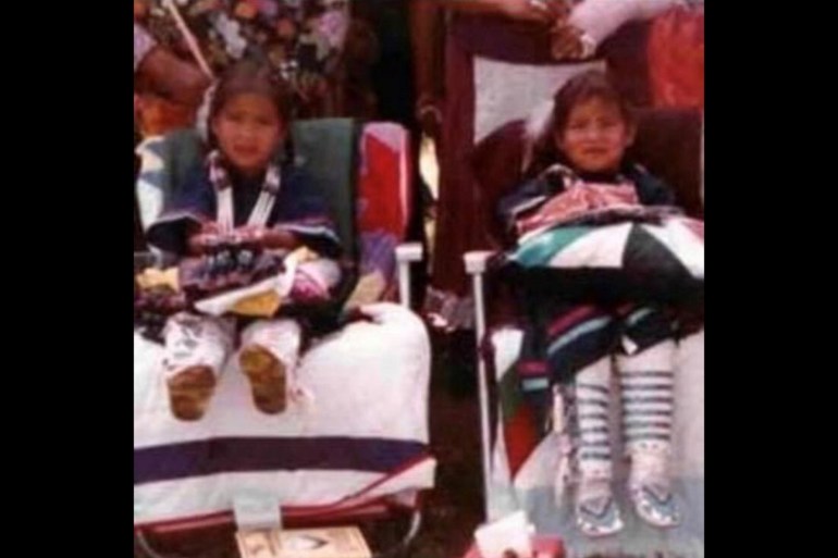A photo of two children sitting in chairs next to each other.