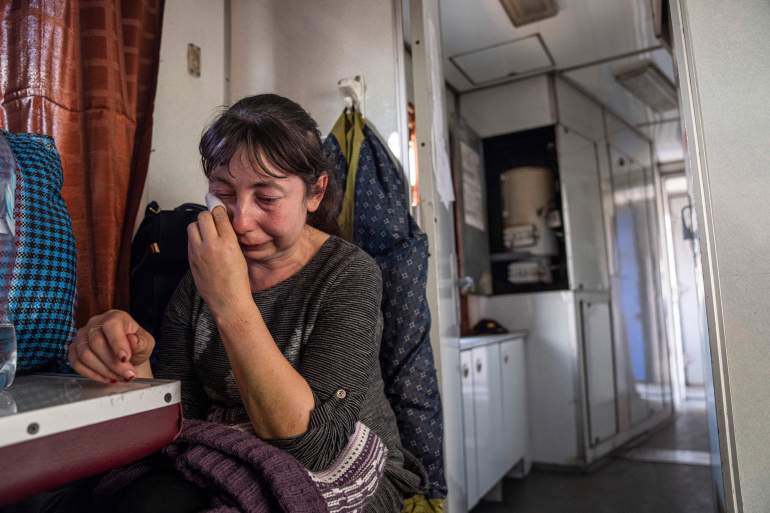A woman from Luhansk region cries while sitting on evacuation train in Pokrovsk, eastern Ukraine,