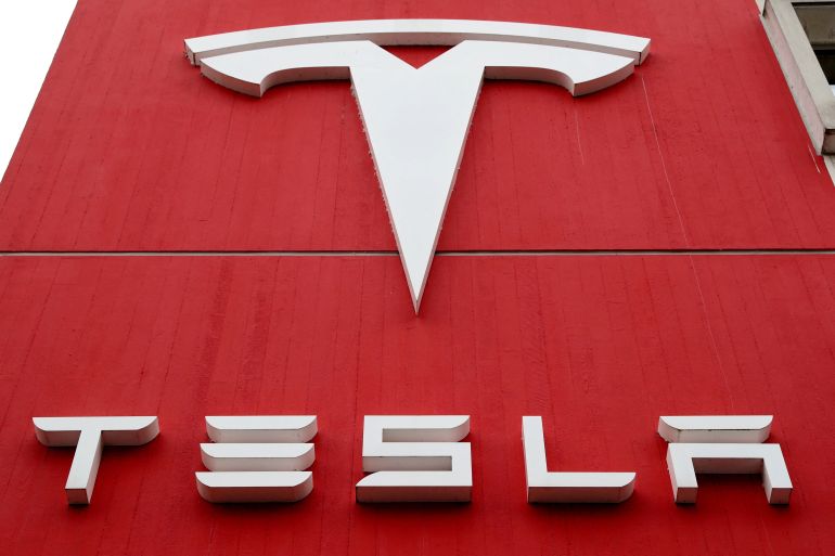 The logo of car manufacturer Tesla is seen at a branch office in Bern, Switzerland