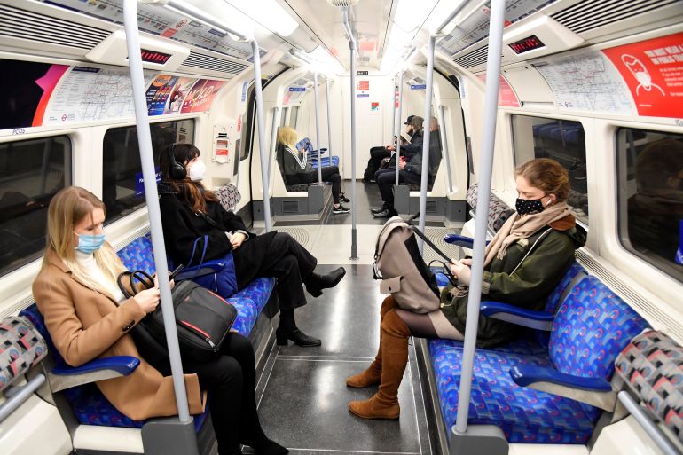 Workers travel on a Jubilee Line underground train during the morning rush-hour, in London, Britain
