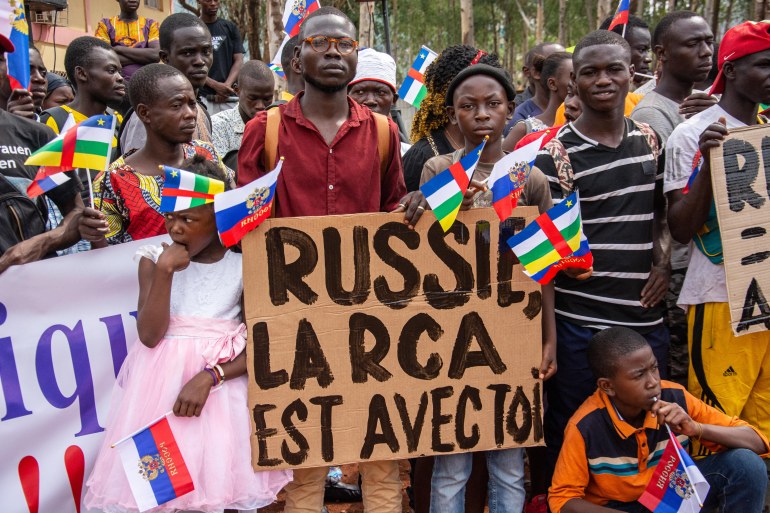 Holding placards with pro Russian slogans, demonstrators gather in Bangui on March 5, 2022 during a rally in support of Russia.