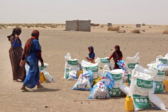 Poor Yemeni families receive flour rations and other basic food supplies from charities