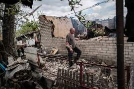 Volodymyr Krylovskii walks at his destroyed house hit by shelling in the morning as all family members were safe in the basement of the garage in Lyman, eastern Ukraine [File: Yasuyoshi Chiba/AFP]