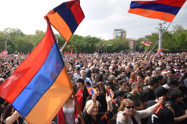 A crowd of demonstrators wave national flags as they attend an opposition rally in Yerevan on May 1, 2022, held to protest against Karabakh concessions