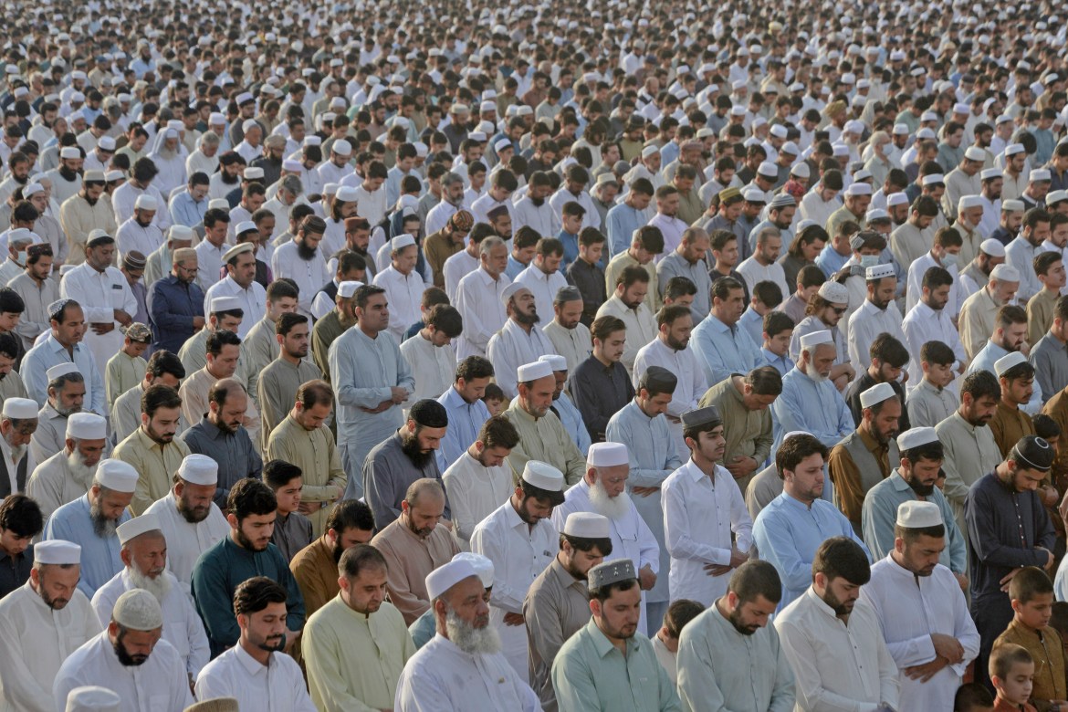 Muslim devotees offer a special morning prayer to start the Eid al-Fitr festival, which marks the end of their holy fasting month of Ramadan, in Peshawar