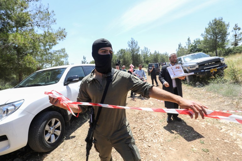 Israeli security members cordon off a forest area near the central city of Elad
