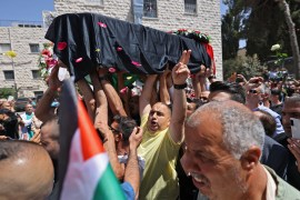 The body of slain veteran Al Jazeera journalist Shireen Abu Akleh arrives at a hospital in the occupied East Jerusalem neighbourhood of Sheikh Jarrah [AFP]