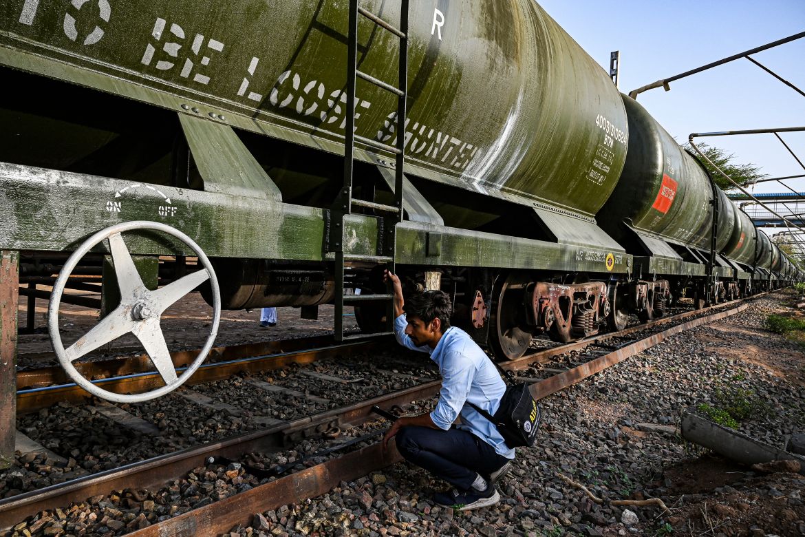 A railway employee inspecting a tanker filled with water of a special train before dispatching for the Pali