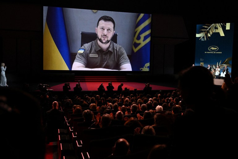Ukrainian President Volodymyr Zelenskyy addresses guests during the Opening Ceremony of the Cannes Film Festival on May 17, 2022 [Christophe Simon/AFP]