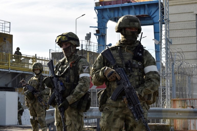 Russian servicemen patrolling at the Kakhovka Hydroelectric Power Plant, Kherson Oblast