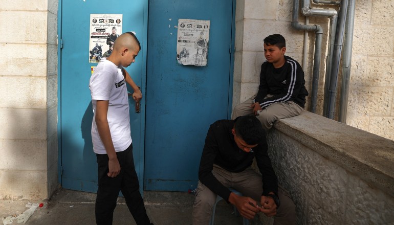 Young relatives of a 17-year-old Palestinian Amjad Al-Fayed, wait to see his corpse outside a hospital morgue 