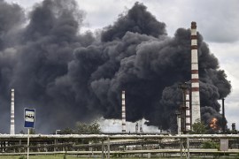 Smoke rises from an oil refinery after an attack outside the city of Lysychansk [Aris Messinis/AFP]