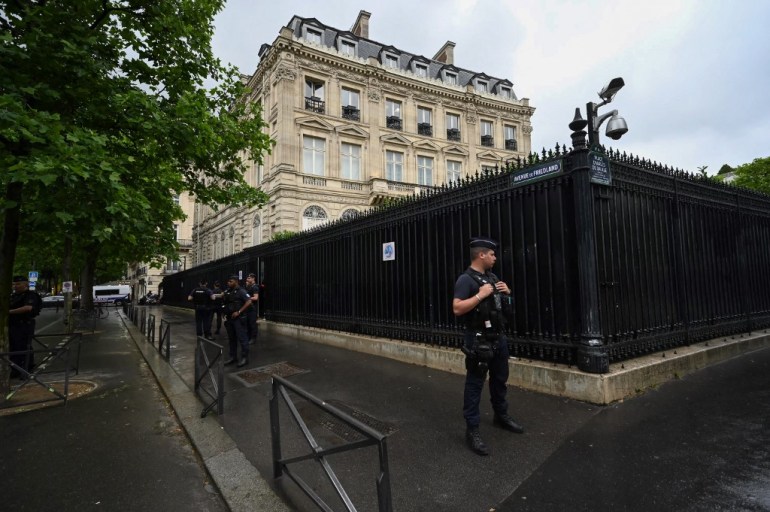 French policemen take position outside the Qatar Embassy in Paris