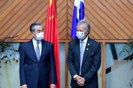Secretary-General of the Pacific Islands Forum Henry Puna (R) and Chinese Foreign Minister Wang Yi (L) pose for photographs during their meeting in Fiji's capital city of Suva.