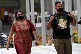 Subhas Nair, in a black t-shirt emblazoned with the face of death row prisoner Naganethran Dhamalingam, walks to court with his sister Preeti
