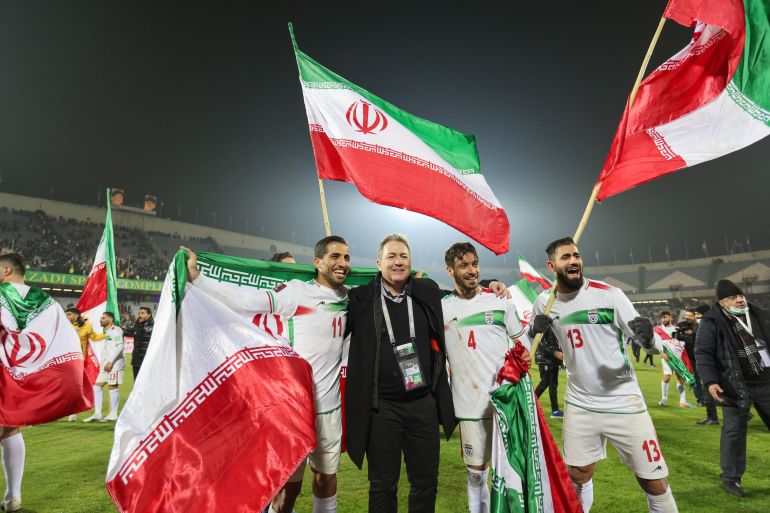 Iran's players celebrate with their fans