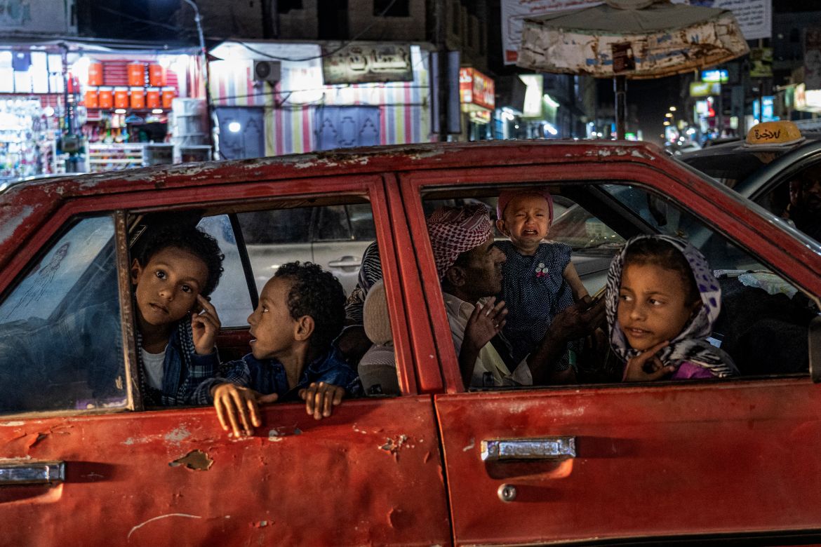 A family waits in their car, stuck in a traffic jam in Al Ghaydah