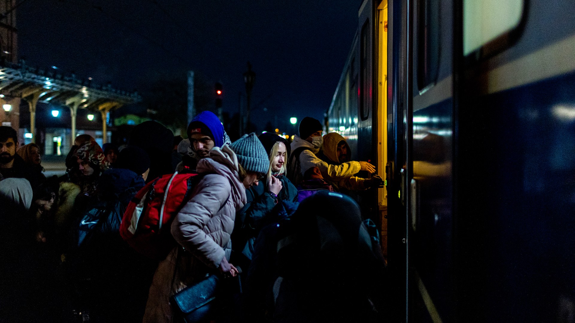 People wait to board a train
